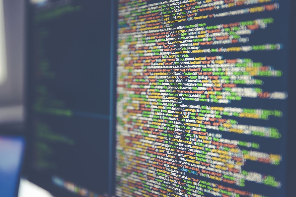 Source code on a monitor — the same code path WPGuard's agent and dashboard are both built from